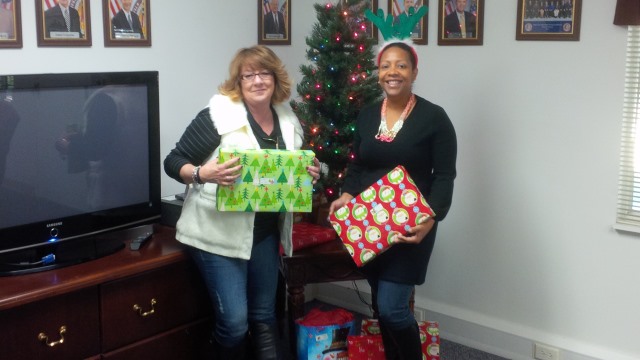FLETA Program Analysts Liz Dodson and Stephanie Archbold prepare the gifts to present to CASA. FLETA Program Analysts Liz Dodson and Stephanie Archbold prepare the gifts to present to CASA.