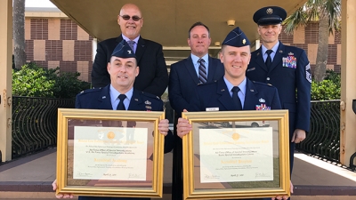 Members of the U.S. Air Force Special Investigations Academy holding their accreditation certificates