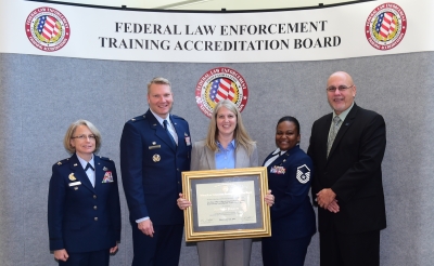 AFOSI staff accepts the certificate of accreditation. AFOSI staff accepts the certificate of accreditation.