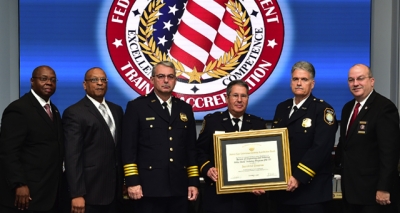 Bureau of Engraving and Printing staff holding the FLETA accreditation certificate Bureau of Engraving and Printing staff holding the FLETA accreditation certificate
