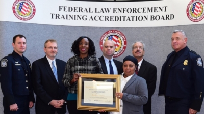 CBP and USDA staff accept the certificate of accreditation for the CBPAS.