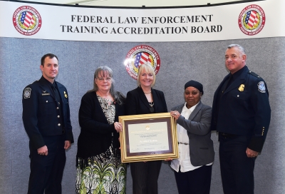 CBP Field Operations Academy staff accept the certificate for the academy accreditation. CBP Field Operations Academy staff accept the certificate for the academy accreditation.