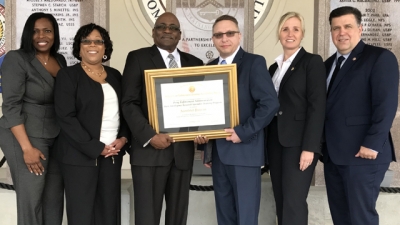 Representatives from the Drug Enforcement Administration hold the FLETA Accreditation Certificate Representatives from the Drug Enforcement Administration hold the FLETA Accreditation Certificate