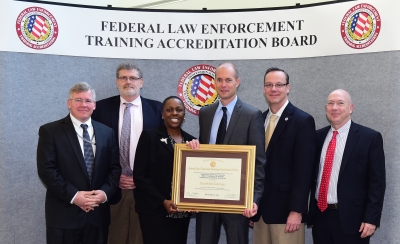 DHS Office of Intelligence staff accepts the certificate of accreditation. DHS Office of Intelligence staff accepts the certificate of accreditation.