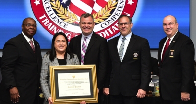DHS Intelligence Training Academy staff holding the FLETA accreditation certificate DHS Intelligence Training Academy staff holding the FLETA accreditation certificate