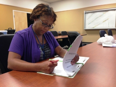 A FLETA Assessor reviews an agency file. A FLETA Assessor reviews an agency file.