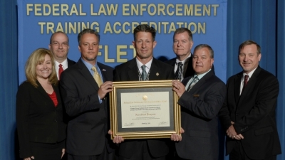 Federal Law Enforcement Training Centers staff present their reaccreditation certificate for the Uniformed Police Training Program