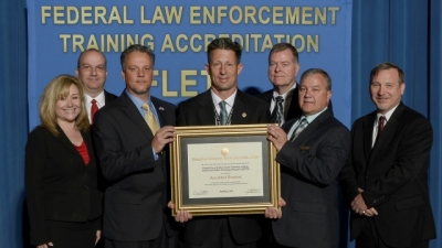 Federal Law Enforcement Training Centers staff present their reaccreditation certificate for the Uniformed Police Training Program Federal Law Enforcement Training Centers staff present their reaccreditation certificate for the Uniformed Police Training Program