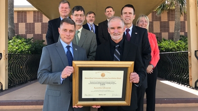 FLETC personnel hold their certificate of accreditation FLETC personnel hold their certificate of accreditation