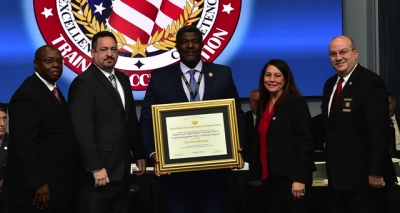 FLETC staff holding the FLETA accreditation certificate FLETC staff holding the FLETA accreditation certificate