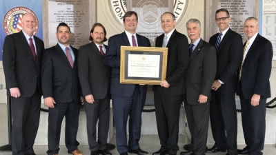 Representatives from the Federal Reserve Board hold the FLETA Accreditation Certificate Representatives from the Federal Reserve Board hold the FLETA Accreditation Certificate