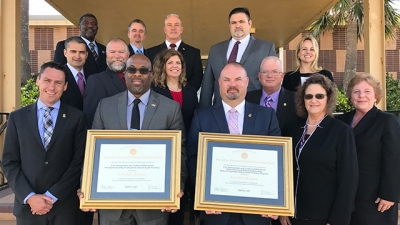 ICE members hold their certificates of accreditation