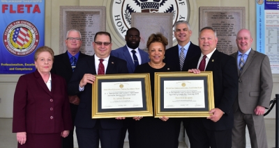 Immigration and Customs Enforcement staff holding the FLETA accreditation certificates Immigration and Customs Enforcement staff holding the FLETA accreditation certificates