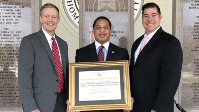 Representatives from the Inspector General Criminal Investigator Academy hold the FLETA Accreditation Certificate Representatives from the Inspector General Criminal Investigator Academy hold the FLETA Accreditation Certificate