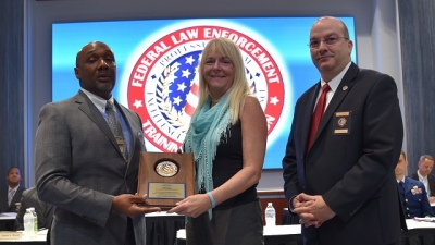 Julie Custer Altman Accepts the Team Leader Recognition Award from Mr. Domenic McClinton and Mr. Joseph Collins Julie Custer Altman Accepts the Team Leader Recognition Award from Mr. Domenic McClinton and Mr. Joseph Collins