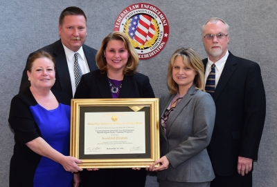 TIGTA staff accept the certificate of accreditation. TIGTA staff accept the certificate of accreditation.