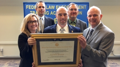 Members from the Transportation Security Administration with their certificate of reaccreditation Members from the Transportation Security Administration with their certificate of reaccreditation
