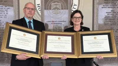 Representatives from the Transportation Security Administration hold the three FLETA Accreditation Certificates