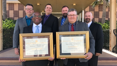 USAMPS members hold their certificates of accreditation USAMPS members hold their certificates of accreditation