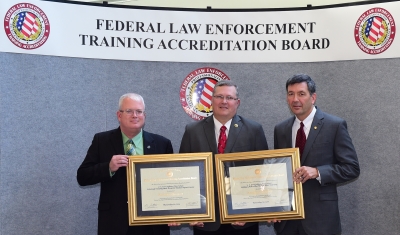 USAMPS staff accept the certificates of accreditation. USAMPS staff accept the certificates of accreditation.