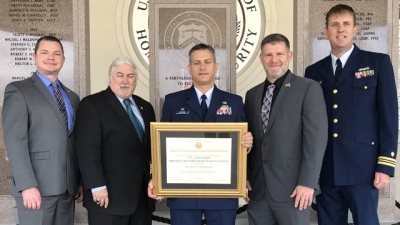 Members from the United States Coast Guard hold the FLETA Accreditation Certificate