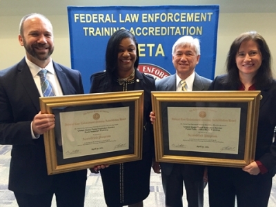 Members from the United States Postal Inspection Service with the certificates for reaccreditation for their programs Members from the United States Postal Inspection Service with the certificates for reaccreditation for their programs