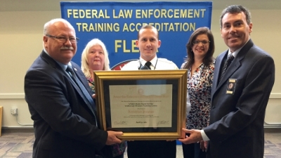 Members of the United States Secret Service accept their certificate of accreditation from Dr. Gary Mitchell and FLETA Board Chair Brian Peters Members of the United States Secret Service accept their certificate of accreditation from Dr. Gary Mitchell and FLETA Board Chair Brian Peters