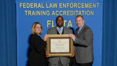 Dept. of Veterans Affairs Law Enforcement Training Center staff present their reaccreditation certificate Dept. of Veterans Affairs Law Enforcement Training Center staff present their reaccreditation certificate