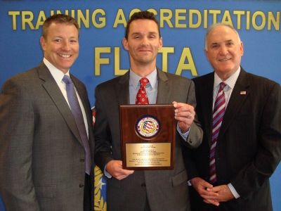 Jason Worchel (center) is joined by Michael Novak, Assistant Administrator, Training and Workforce Engagement (left) and Thomas Kost, Division Director, Law Enforcement and Industry Training Division (right)
