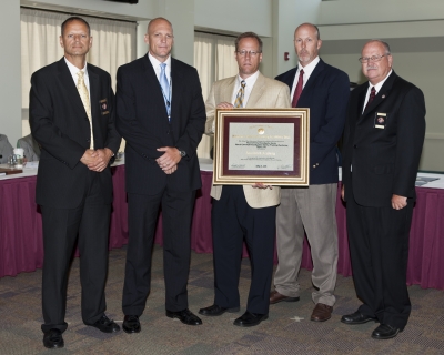 FLETA Board Chair, Ronald Ward; SSA Norman Dominesey, Advanced Trng NCIS Academy; Scott Hickson, ISS, NCIS Academy; SA Thomas Mockler, STP Prgm Mgr; FLETA Office of Accreditation Exec Dir Gary Mitchell, Ph.D. FLETA Board Chair, Ronald Ward; SSA Norman Dominesey, Advanced Trng NCIS Academy; Scott Hickson, ISS, NCIS Academy; SA Thomas Mockler, STP Prgm Mgr; FLETA Office of Accreditation Exec Dir Gary Mitchell, Ph.D.